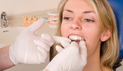 woman being fitted for invisalign