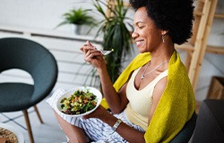 Smiling woman enjoying nutrient-dense meal outside