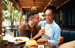 Couple smiling while enjoying meal at restaurant