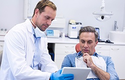 A male patient consulting with his dentist