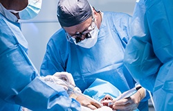 Dentists performing a dental implant surgery