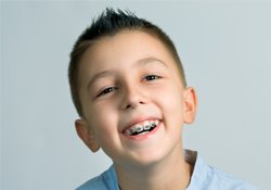 Smiling young boy with braces