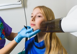 Girl receiving digital dental x-rays