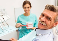 Smiling senior man in dental chair