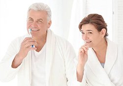 Senior couple brushing teeth
