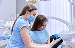 A woman paying the cost of veneers