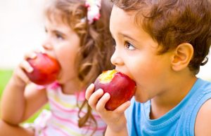 Children eating apples.