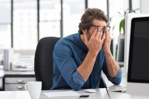 Man tired at work desk