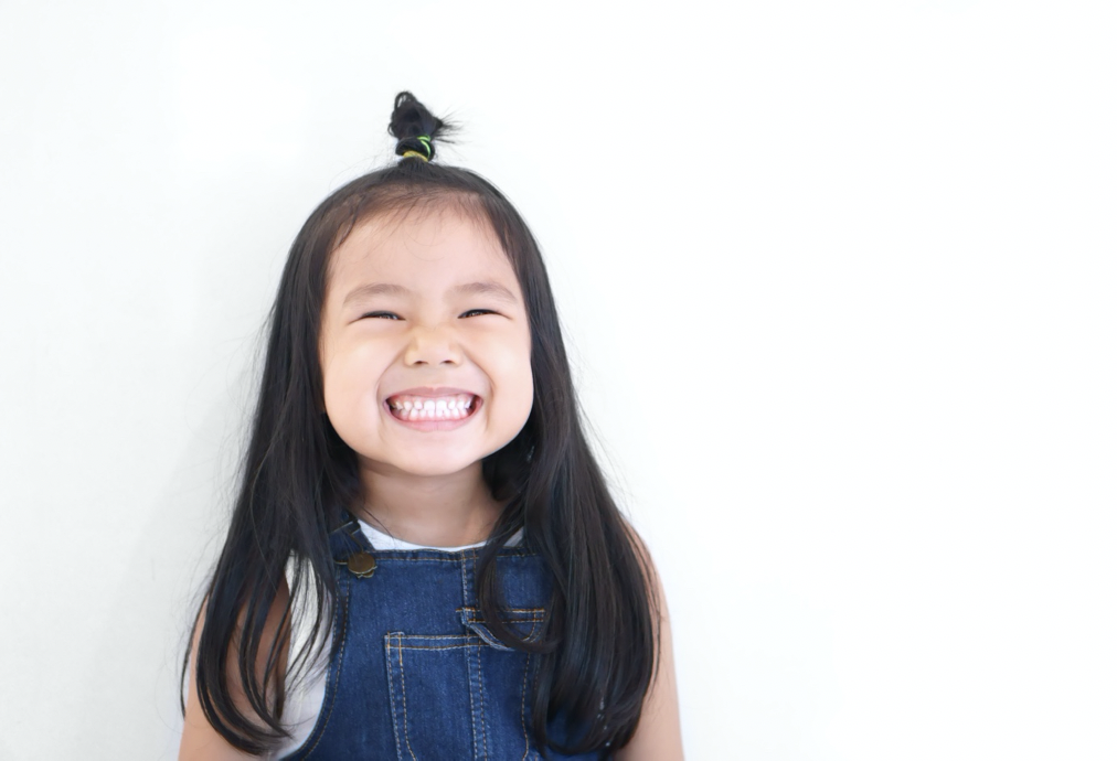 little girl smiling about cavity-causing foods