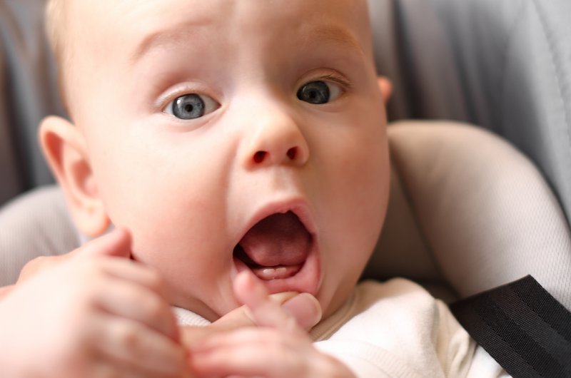 A baby showing baby teeth