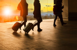 people traveling with sleep apnea walking in airport with luggage