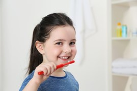 small child brushing teeth 