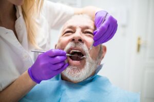 Older man having work done by a dentist